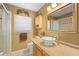 Bathroom featuring a vessel sink, framed mirror, and glass-enclosed shower at 707 24Th Sw St, Largo, FL 33770