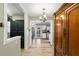 Bright hallway leads to kitchen, featuring hardwood floors and a large armoire at 707 24Th Sw St, Largo, FL 33770