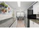 Bright kitchen featuring granite countertops, tile backsplash, stainless steel refrigerator and eat-in dining area at 707 24Th Sw St, Largo, FL 33770