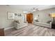 Open-concept living room featuring hardwood floors, neutral paint, a ceiling fan, and comfortable seating at 707 24Th Sw St, Largo, FL 33770
