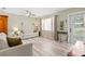 Bright living room features hardwood floors, neutral paint, a ceiling fan, and plenty of space for entertaining at 707 24Th Sw St, Largo, FL 33770
