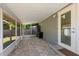 View of the screened porch with neutral paint and door access to the home's interior at 707 24Th Sw St, Largo, FL 33770