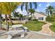 Enjoy an outdoor dining space and private dock, complemented by a manicured lawn and tropical plants at 7109 Pelican Island Dr, Tampa, FL 33634