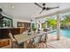Outdoor dining table with seating, a kitchen bar and a view of the pool and comfortable seating at 7109 Pelican Island Dr, Tampa, FL 33634