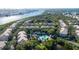 Aerial view of community featuring lush greenery, a central pool, and neatly arranged residential buildings at 716 Promenade Pl, Tampa, FL 33602