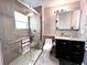 Updated bathroom featuring a glass shower, medicine cabinet, and mosaic-tiled floor at 716 Promenade Pl, Tampa, FL 33602