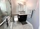 Updated bathroom featuring a glass shower, medicine cabinet, and mosaic-tiled floor at 716 Promenade Pl, Tampa, FL 33602