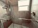 Updated shower featuring a glass shower door and tiled walls at 716 Promenade Pl, Tampa, FL 33602