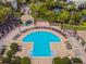 Aerial view of a large community pool with seating and lush landscaping at 716 Promenade Pl, Tampa, FL 33602