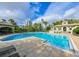 Large community pool with lounge chairs, clubhouse, and tropical landscaping at 716 Promenade Pl, Tampa, FL 33602