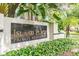 Elegant 'Island Place Private Residences' signage surrounded by lush tropical landscaping at 716 Promenade Pl, Tampa, FL 33602