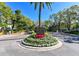 Community entrance sign with colorful flowers and well-maintained landscaping at 716 Promenade Pl, Tampa, FL 33602
