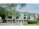 Well-maintained condo building with garages, lush landscaping, and tranquil surroundings at 716 Promenade Pl, Tampa, FL 33602