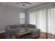 Bright living area with hardwood floors, sheer curtains, and comfortable seating at 716 Promenade Pl, Tampa, FL 33602