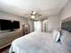 Spacious main bedroom with a television, dresser, and a sliding door to an open closet at 716 Promenade Pl, Tampa, FL 33602