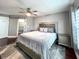 Comfortable main bedroom featuring a ceiling fan and a sliding door to an open closet at 716 Promenade Pl, Tampa, FL 33602