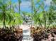 Outdoor patio with dining tables, chairs, lush landscaping, and views of the lake at 716 Promenade Pl, Tampa, FL 33602