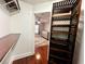 Walk-in closet with custom shelving and hardwood floors at 716 Promenade Pl, Tampa, FL 33602