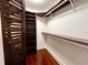Walk-in closet with custom shelving and hardwood floors at 716 Promenade Pl, Tampa, FL 33602