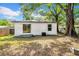 Backyard exterior featuring sliding glass doors and white painted siding at 8504 N 17Th St, Tampa, FL 33604