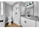 Updated bathroom featuring a walk-in shower, toilet, and vanity with stone countertop at 8504 N 17Th St, Tampa, FL 33604