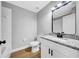 Modern bathroom with toilet, tub, and white vanity with granite countertop at 8504 N 17Th St, Tampa, FL 33604