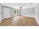 Bedroom featuring a ceiling fan, light gray walls, wood floor, and a bright window at 8504 N 17Th St, Tampa, FL 33604