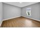 Neutral bedroom features modern flooring, baseboards, and an outside view at 8504 N 17Th St, Tampa, FL 33604