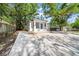 Charming bungalow with a blue door, surrounded by mature trees and a spacious driveway at 8504 N 17Th St, Tampa, FL 33604