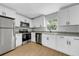 Updated kitchen featuring stainless steel appliances, granite countertops and white cabinetry at 8504 N 17Th St, Tampa, FL 33604