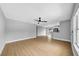 Spacious living room with wood-look flooring and a view to the kitchen with white cabinets at 8504 N 17Th St, Tampa, FL 33604