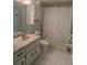 Bathroom features a shower, vanity, and tile floor, creating a clean and efficient space at 861 Maple Ct # 104, Dunedin, FL 34698