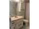 Bathroom featuring vanity with sink, toilet, shower and overhead fan at 861 Maple Ct # 104, Dunedin, FL 34698