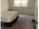 Bedroom features a large bed and neutral tones, creating a serene and inviting personal retreat at 861 Maple Ct # 104, Dunedin, FL 34698
