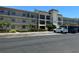 Multi-story condo building featuring balconies, parking, and tropical landscaping, with address number prominently displayed at 861 Maple Ct # 104, Dunedin, FL 34698