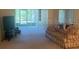 Relaxing living room with sofa, carpet, and large window, creating a serene and welcoming space at 861 Maple Ct # 104, Dunedin, FL 34698