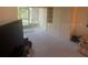 Cozy living room with large window and neutral carpet offers a comfortable space to relax and entertain at 861 Maple Ct # 104, Dunedin, FL 34698