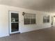 Covered patio with tile flooring, door, windows and outside lighting at 861 Maple Ct # 104, Dunedin, FL 34698