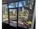 Picturesque view from the screened patio showcasing lush greenery and a serene outdoor setting to enjoy nature at 861 Maple Ct # 104, Dunedin, FL 34698