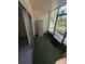 Enclosed sunroom with sliding glass door, offering a tranquil space with outdoor views and natural light at 861 Maple Ct # 104, Dunedin, FL 34698