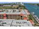 Expansive aerial view of the condo community with a marina, water views, and multiple balconies at 8931 Blind Pass Rd # 360, St Pete Beach, FL 33706