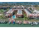 Stunning aerial view of the condo complex with a pool, marina, and lush landscaping at 8931 Blind Pass Rd # 360, St Pete Beach, FL 33706