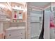 Bathroom with a single sink vanity and tiled shower with a curtain at 8931 Blind Pass Rd # 360, St Pete Beach, FL 33706
