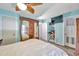 Bedroom with blue walls, wooden floors, TV, and storage at 8931 Blind Pass Rd # 360, St Pete Beach, FL 33706