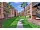 A serene courtyard with a lush lawn, a paved walkway, and multiple balconies overlooking the area at 8931 Blind Pass Rd # 360, St Pete Beach, FL 33706