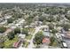 Overhead view of a neighborhood featuring solar panels, tree canopies and well-spaced homes at 9240 53Rd N Way, Pinellas Park, FL 33782