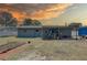Backyard with a covered patio, utility trailer and a new garden, perfect for outdoor living and gardening at 9240 53Rd N Way, Pinellas Park, FL 33782