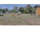 Large backyard with a garden, storage shed, and mature trees, offering a private outdoor space at 9240 53Rd N Way, Pinellas Park, FL 33782