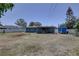 Backyard view featuring a covered patio, garden, utility trailer and great outdoor living space at 9240 53Rd N Way, Pinellas Park, FL 33782