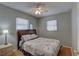 Cozy bedroom features a Paris-themed bedding, windows with blinds, and a neutral color scheme at 9240 53Rd N Way, Pinellas Park, FL 33782